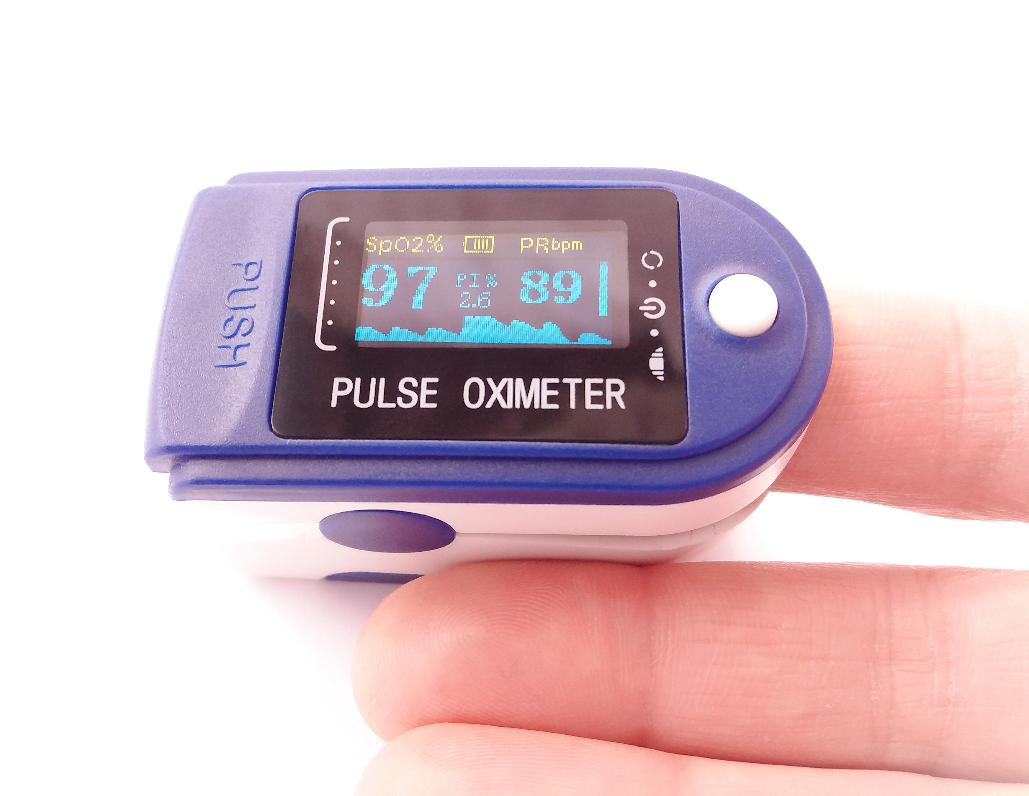 A compact fingertip pulse oximeter showing SpO₂ and pulse rate on a digital display.