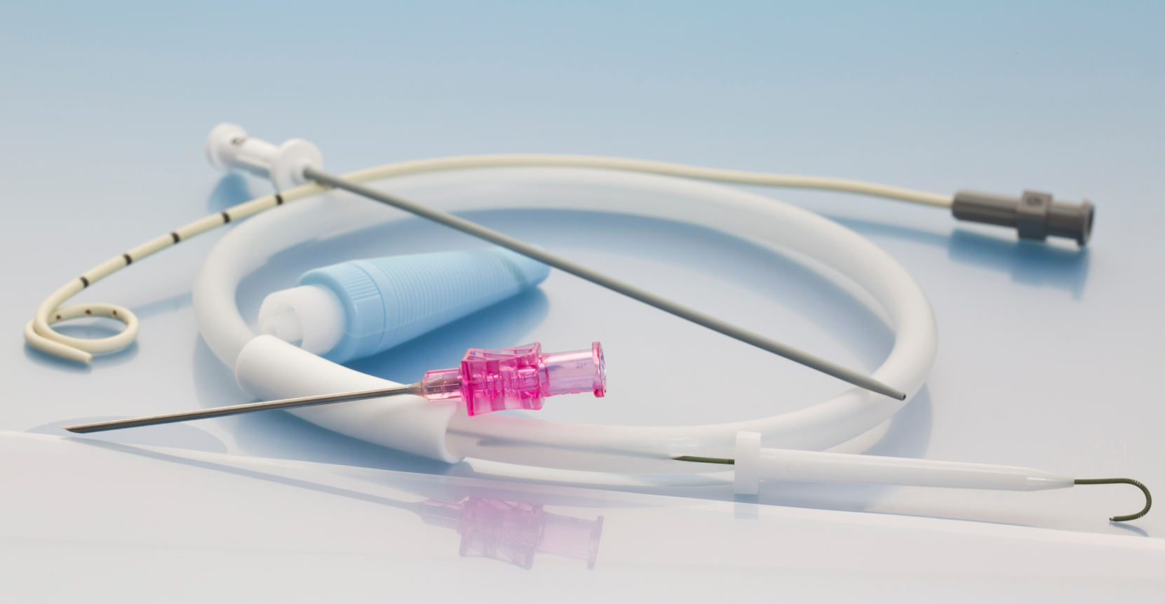 Close-up view of a percutaneous catheter system, showcasing its flexible tubing, radiopaque markings, and connected accessories, designed for minimally invasive medical procedures.