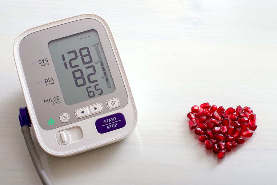  A digital blood pressure monitor with a clear LCD screen displaying systolic, diastolic, and pulse rate readings.