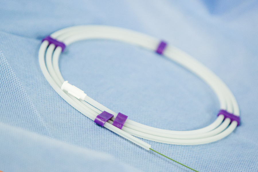 A flexible catheter with a metal guidewire, showcasing its design for vascular navigation. 